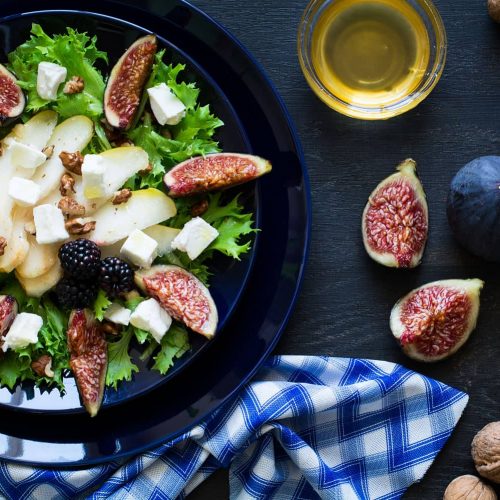 salad-with-pears-lettuce-figs-walnuts-goat-cheese-walnuts-and-honey-on-black-background_t20_8B8a1W